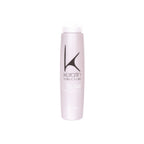 A bottle of Reconstructive Shampoo by Keratin Structure, primarily pink in color with black text and branding.