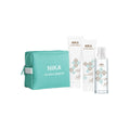 NIKA Riviera Breeze haircare set with two bottles and a pouch on a white background