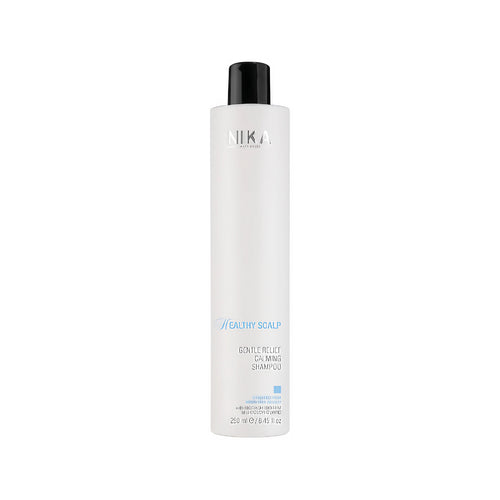Bottle of Nika Gentle Relief Shampoo with a white and blue label, indicating it is for sensitive scalp relief.
