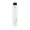A tall white bottle of Pure Keratin Reconstructing Shampoo with blue and green label text, designed for hair care.
