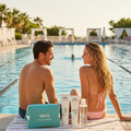 Couple sitting by a pool with Nika riviera breeze products on a towel