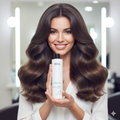 Woman with long, wavy hair holding a Nika hair product , ultimate treatment, pure keratin in a salon setting